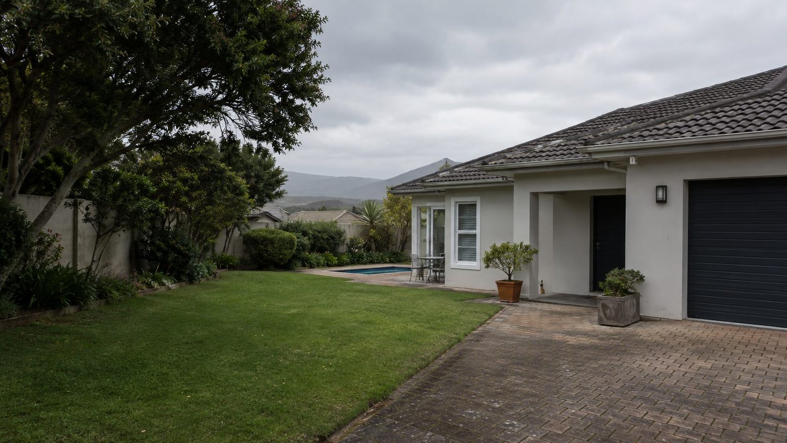 Cleaned home with paved driveway, lawn and pool in the Overberg